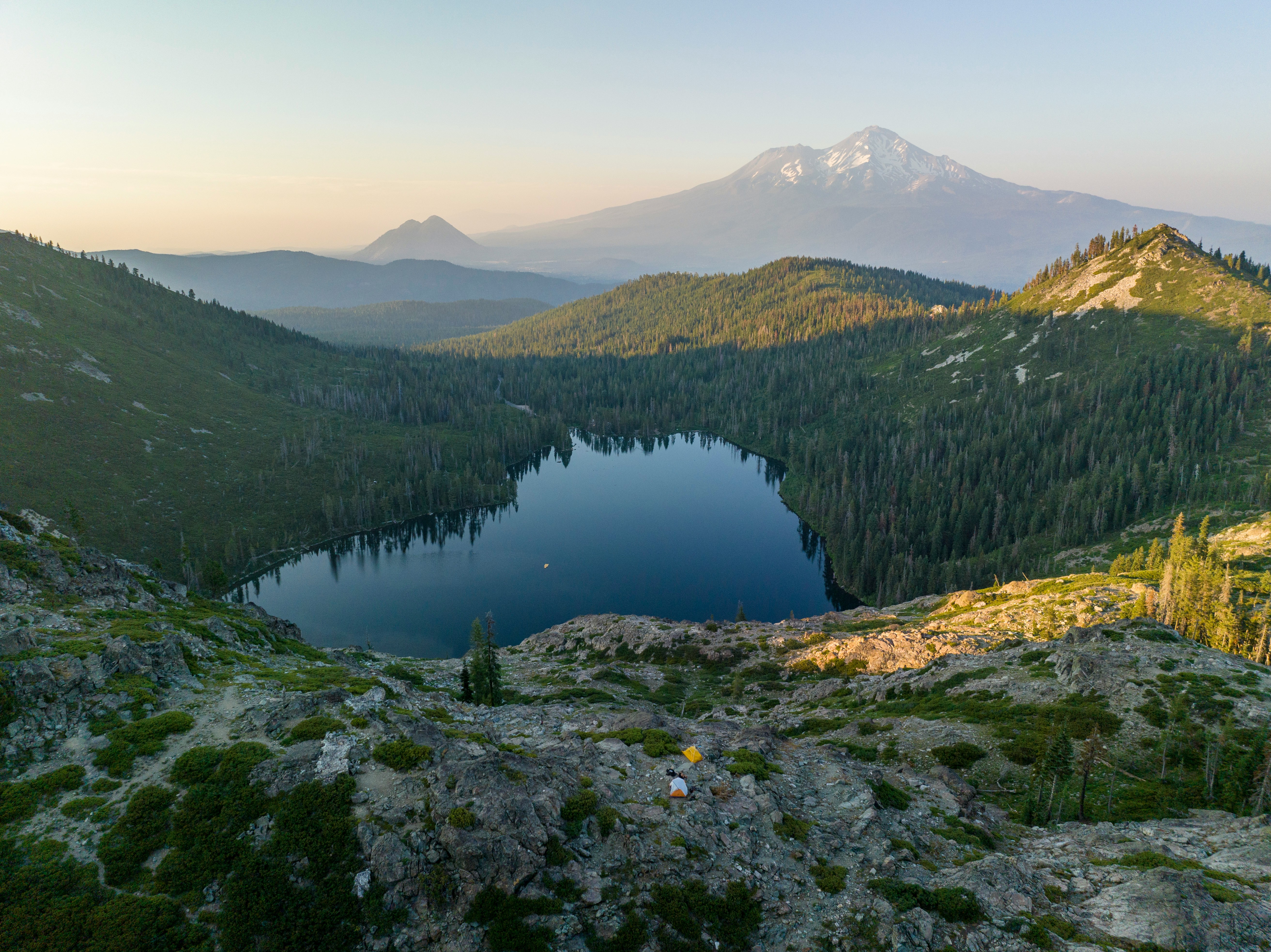 Mount Shasta rising beyond an alpine lake in Northern California
